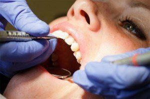 Female patient getting deep dental cleaning